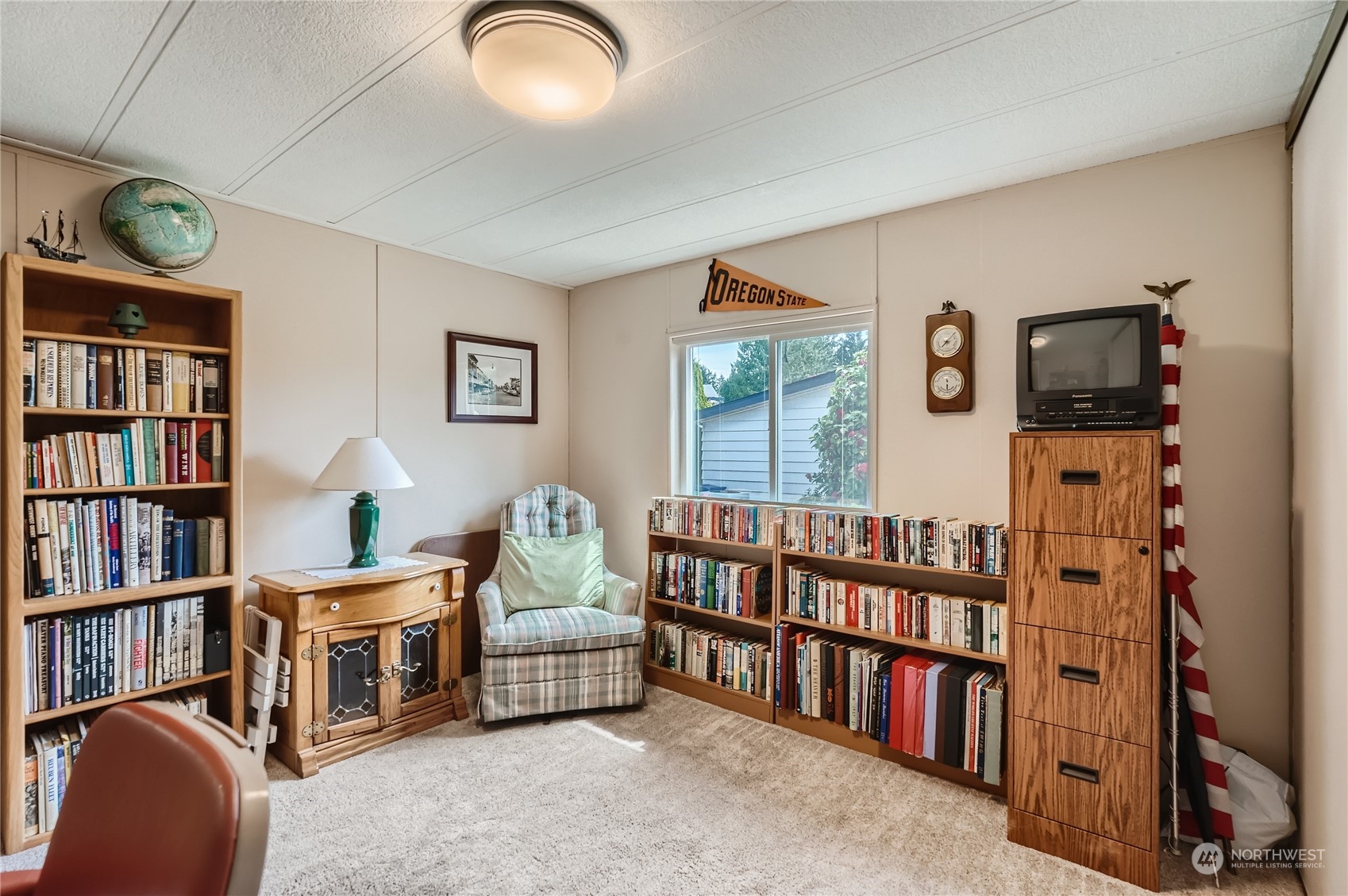 2500 South 370th Street, Unit 196 Federal Way, WA 98003 - Photo 23 of 29 a living room with furniture and a book shelf