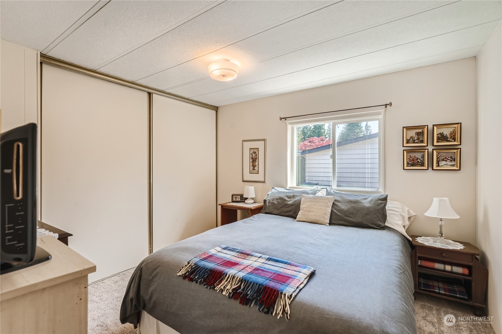 2500 South 370th Street, Unit 196 Federal Way, WA 98003 - Photo 24 of 29 a bedroom with a large bed and a flat tv screen