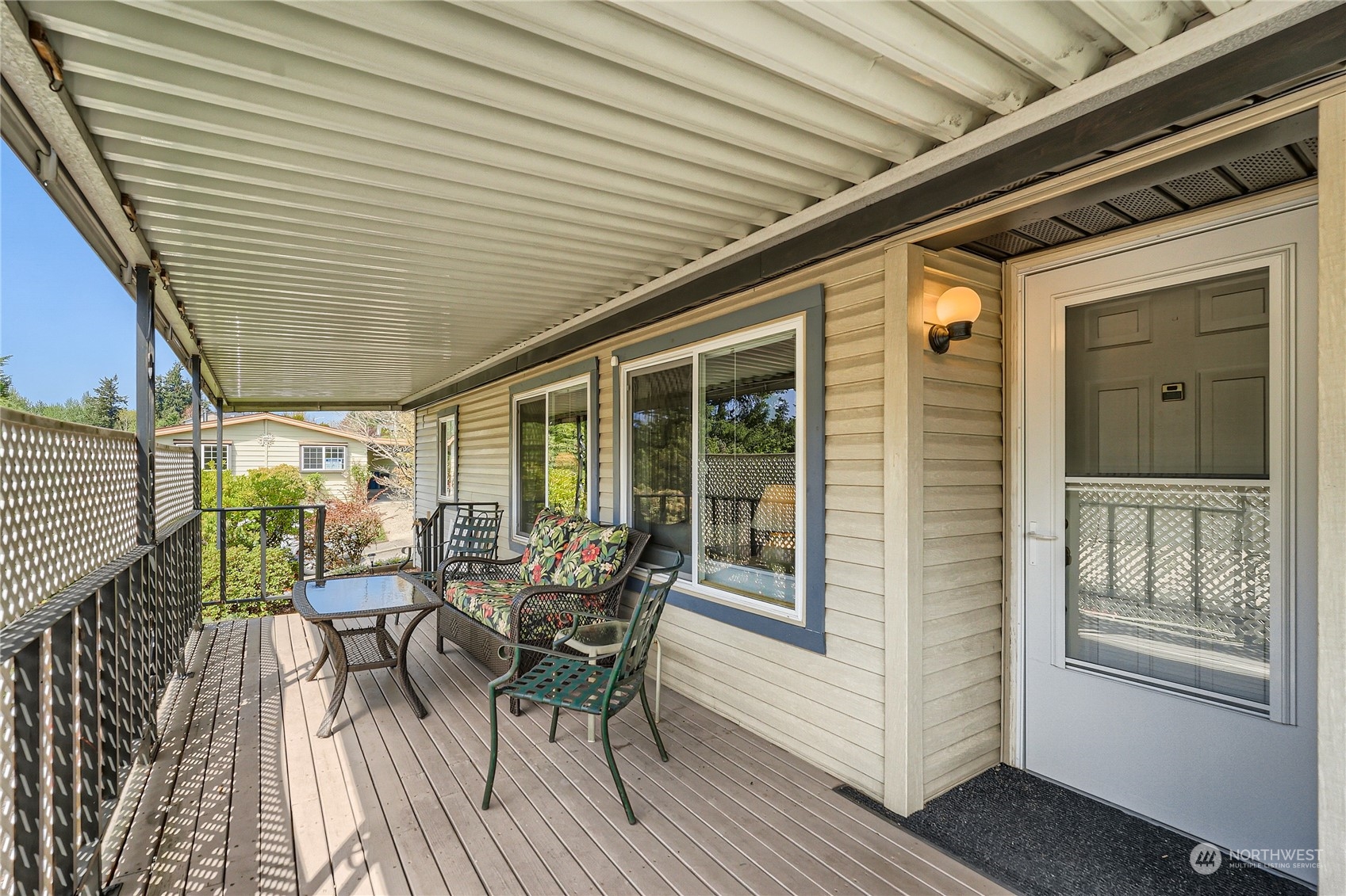 2500 South 370th Street, Unit 196 Federal Way, WA 98003 - Photo 27 of 29 a view of a patio with table and chairs and wooden floor