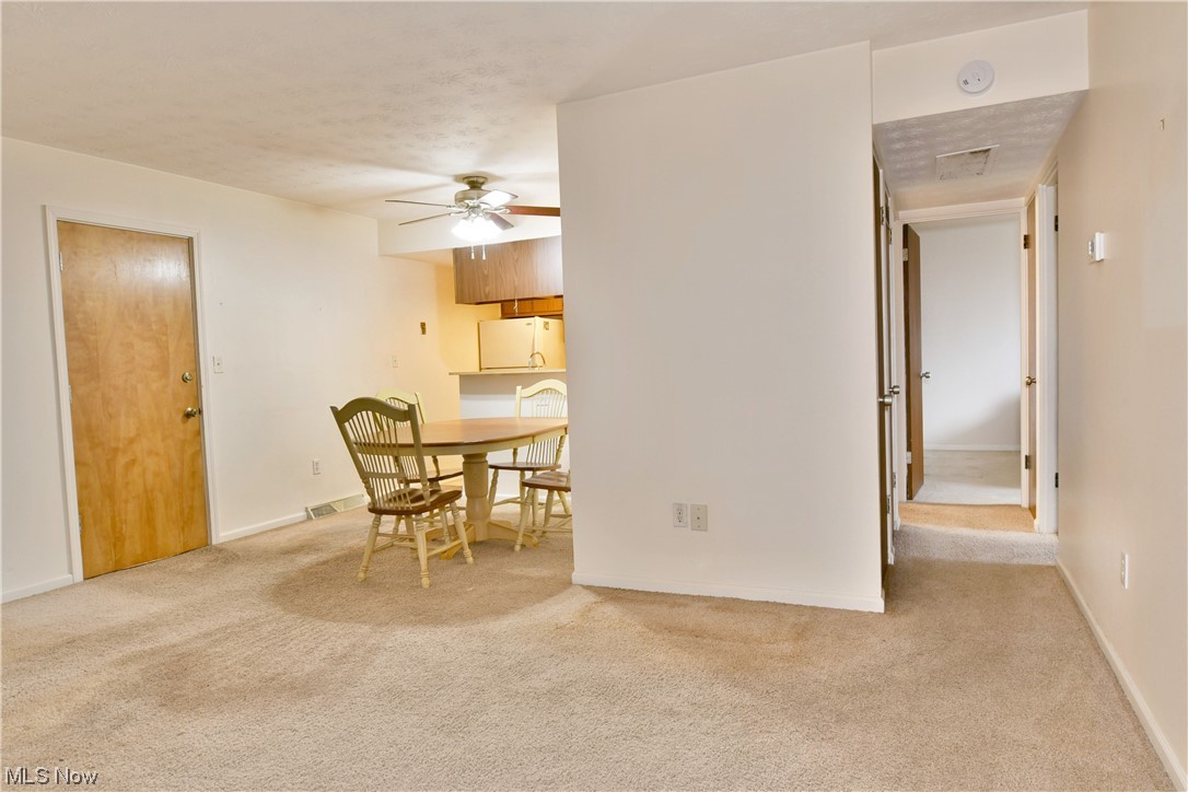 2980 North River Road Northeast, Unit E3 Warren, OH 44483 - Photo 11 of 27 Dining area with ceiling fan and light carpet