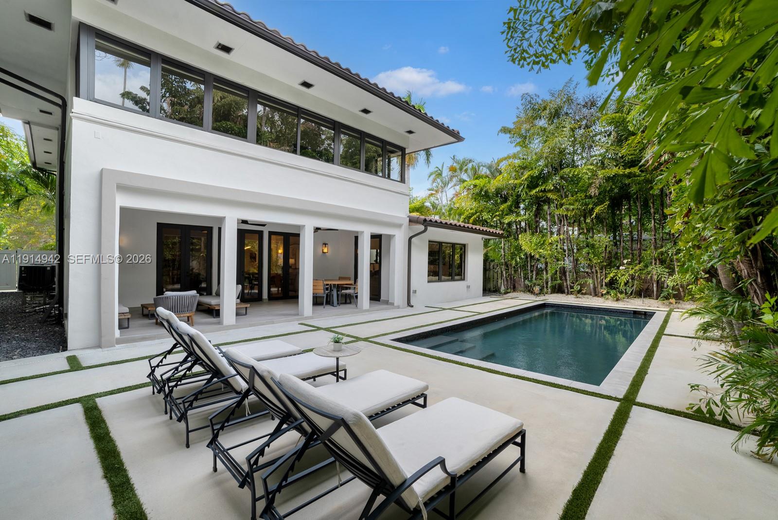 a view of house with swimming pool and sitting area