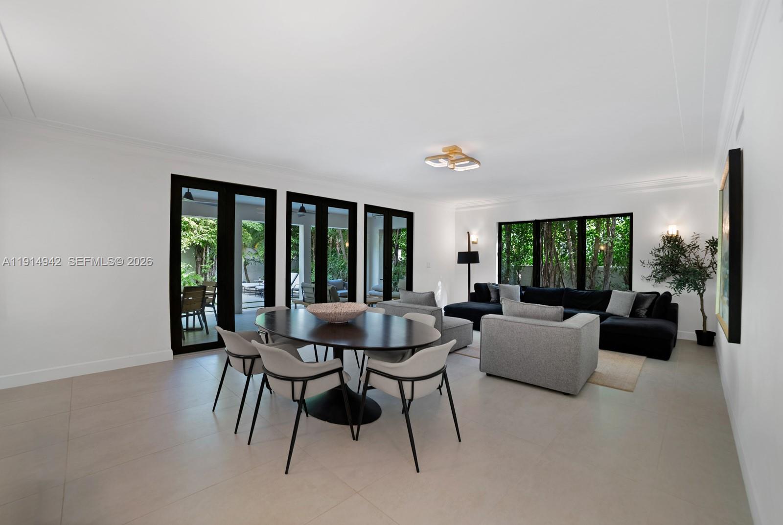 5735 North Bay Road Miami Beach, FL 33140 - Photo 11 of 59 a dining room with furniture and a large window
