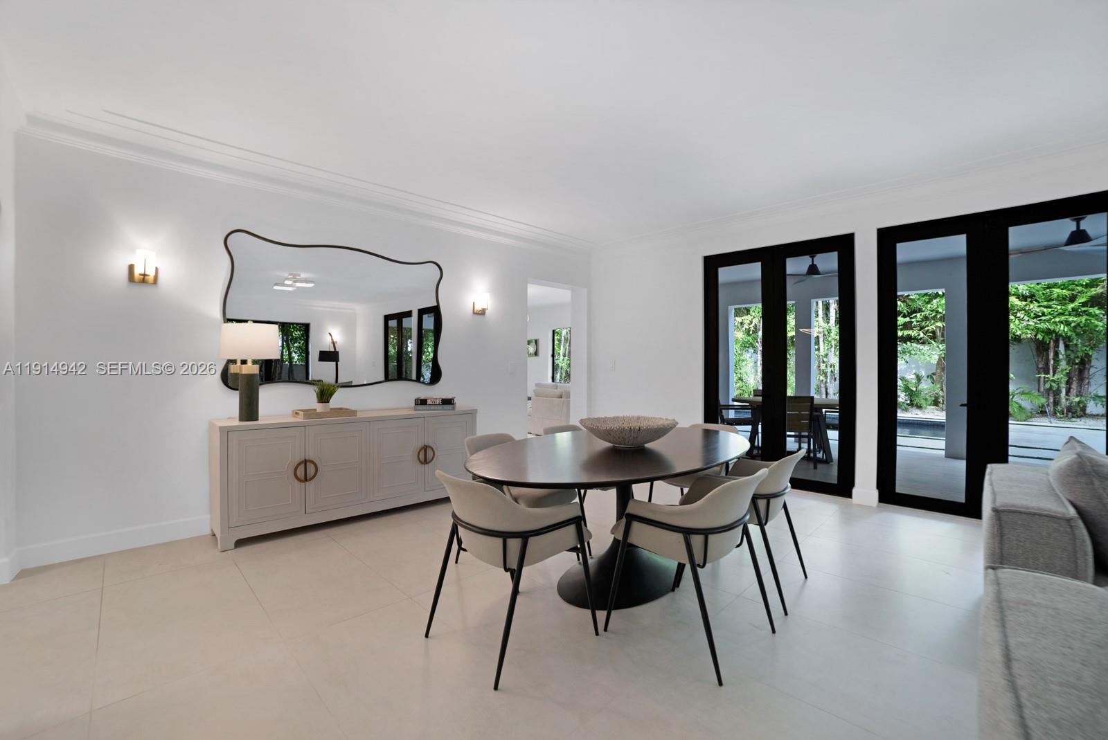 5735 North Bay Road Miami Beach, FL 33140 - Photo 12 of 59 a view of a dining room with furniture and a large window
