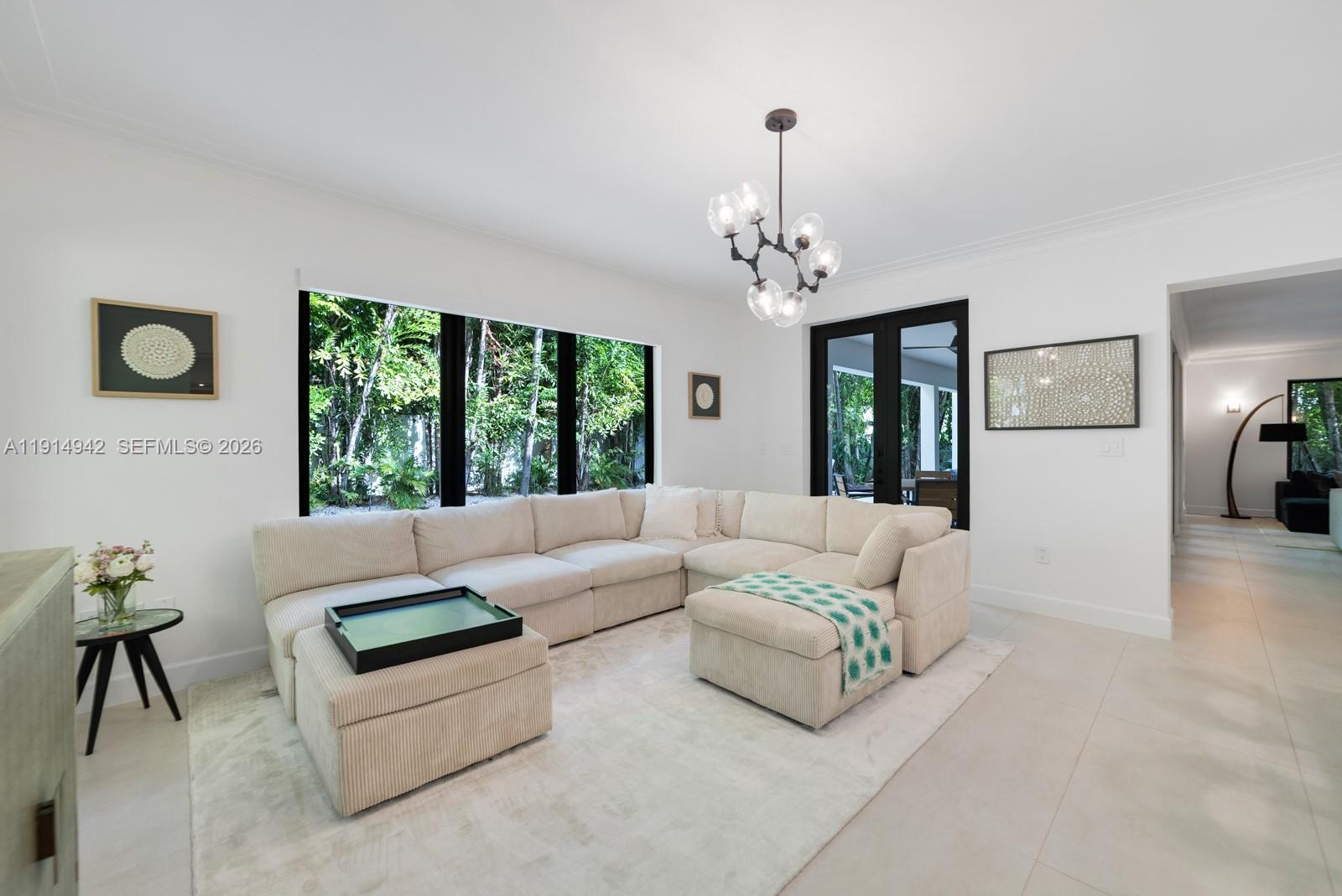 5735 North Bay Road Miami Beach, FL 33140 - Photo 13 of 59 a living room with furniture and a chandelier