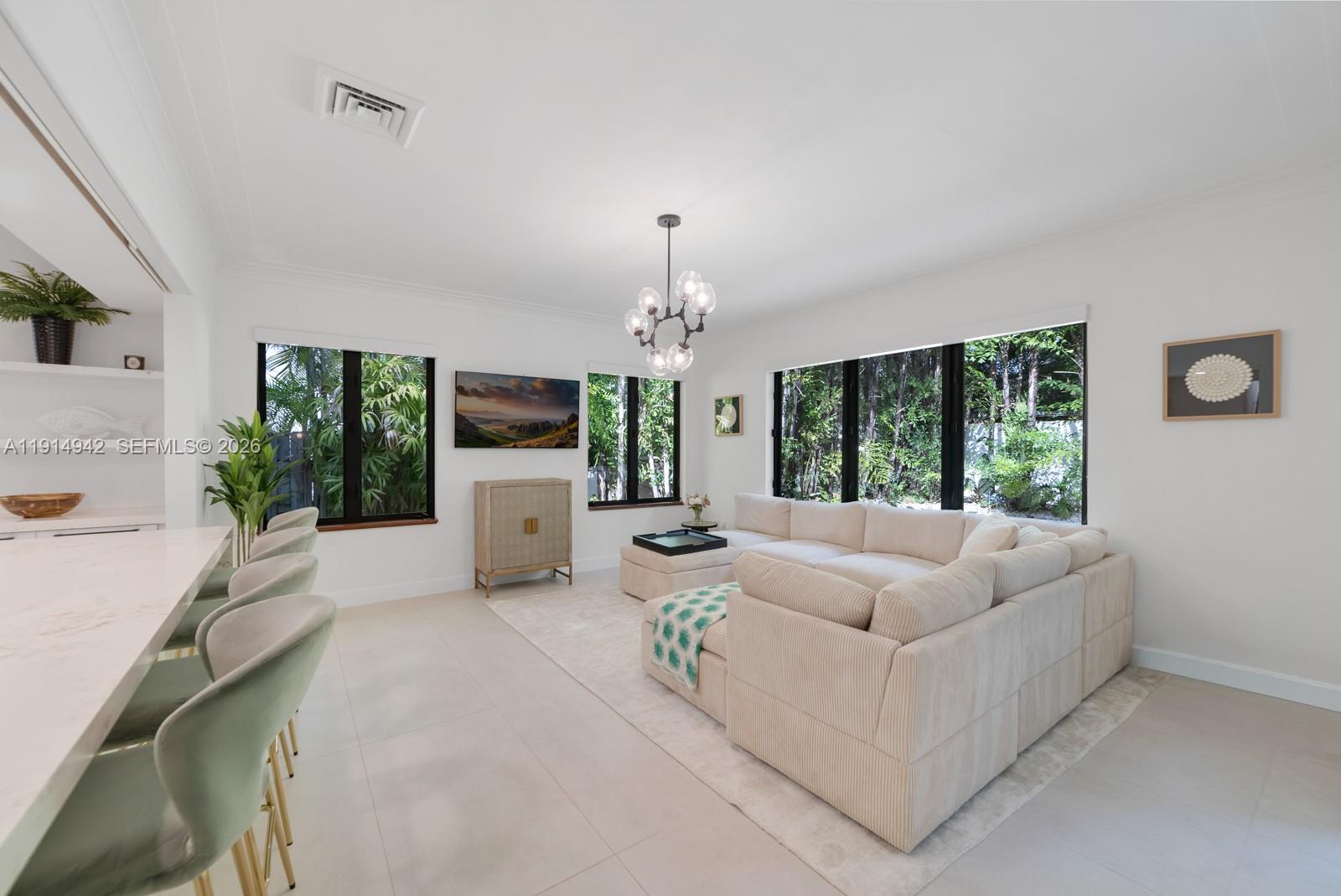 5735 North Bay Road Miami Beach, FL 33140 - Photo 14 of 59 a living room with furniture and a chandelier