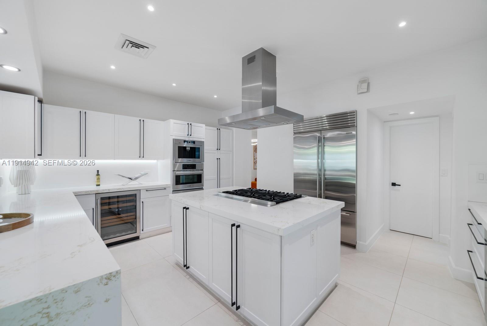 5735 North Bay Road Miami Beach, FL 33140 - Photo 17 of 59 a kitchen that has a stove and a refrigerator