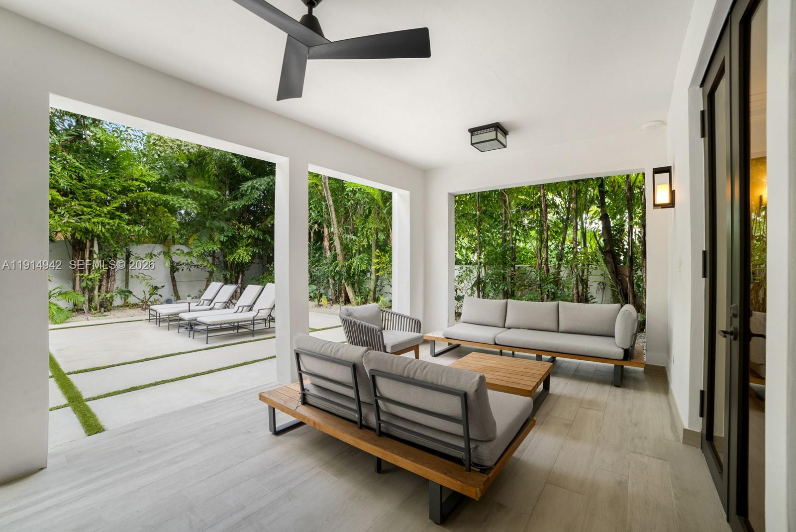 5735 North Bay Road Miami Beach, FL 33140 - Photo 21 of 59 a living room with furniture and a large window