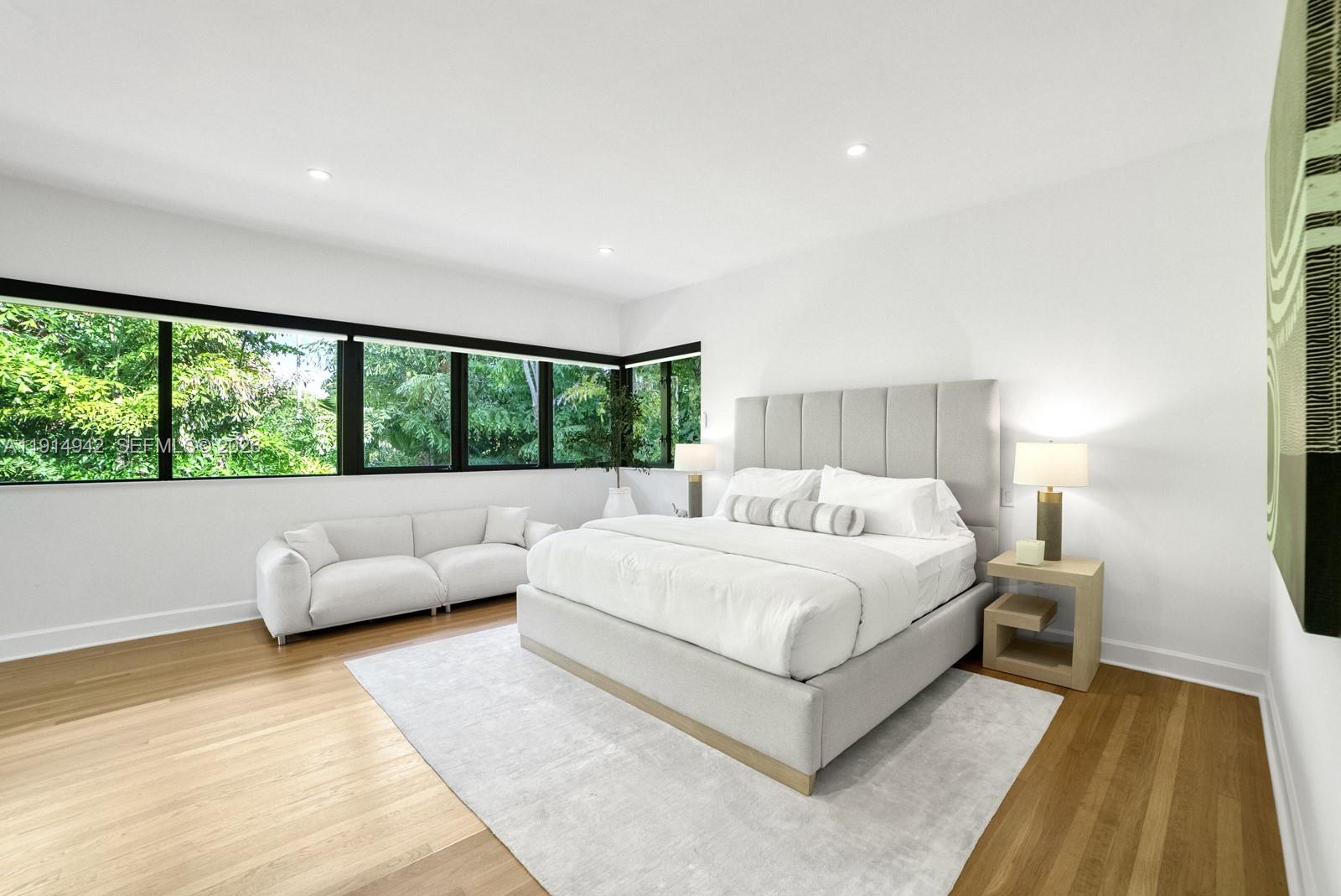 5735 North Bay Road Miami Beach, FL 33140 - Photo 29 of 59 a bed room with a bed and a large window