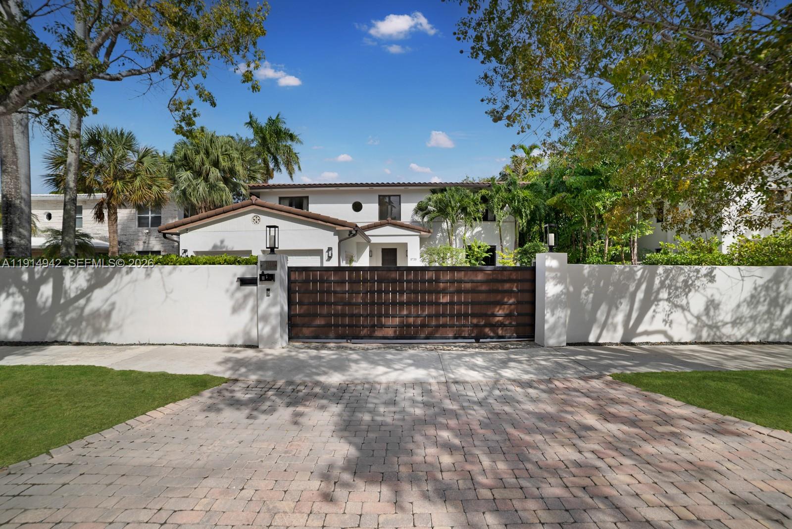5735 North Bay Road Miami Beach, FL 33140 - Photo 3 of 59 a view of a house with a yard and tree