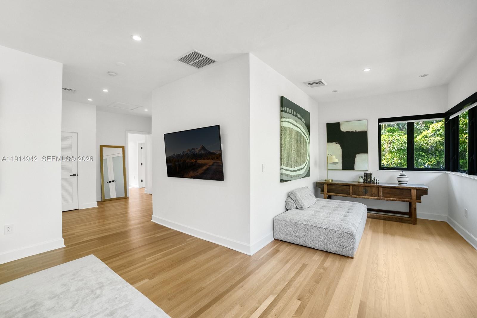 5735 North Bay Road Miami Beach, FL 33140 - Photo 31 of 59 a living room with furniture and a flat screen tv