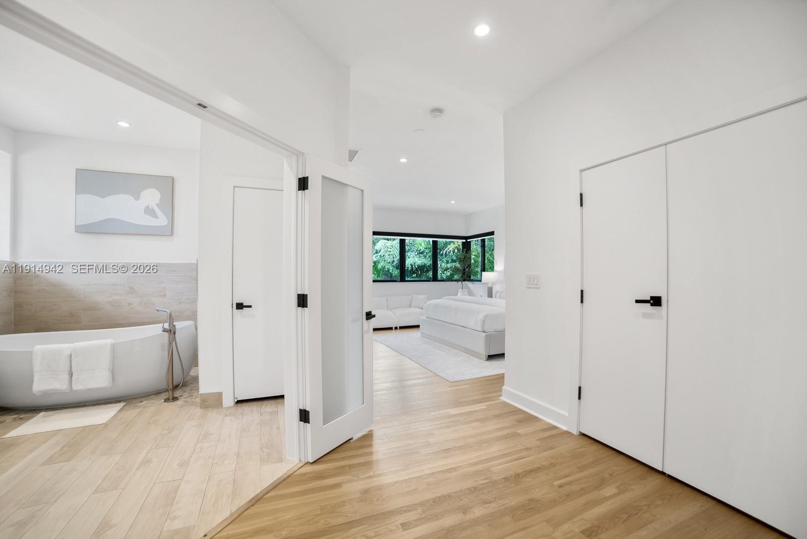 5735 North Bay Road Miami Beach, FL 33140 - Photo 32 of 59 a view of a hallway with wooden floor and cabinet