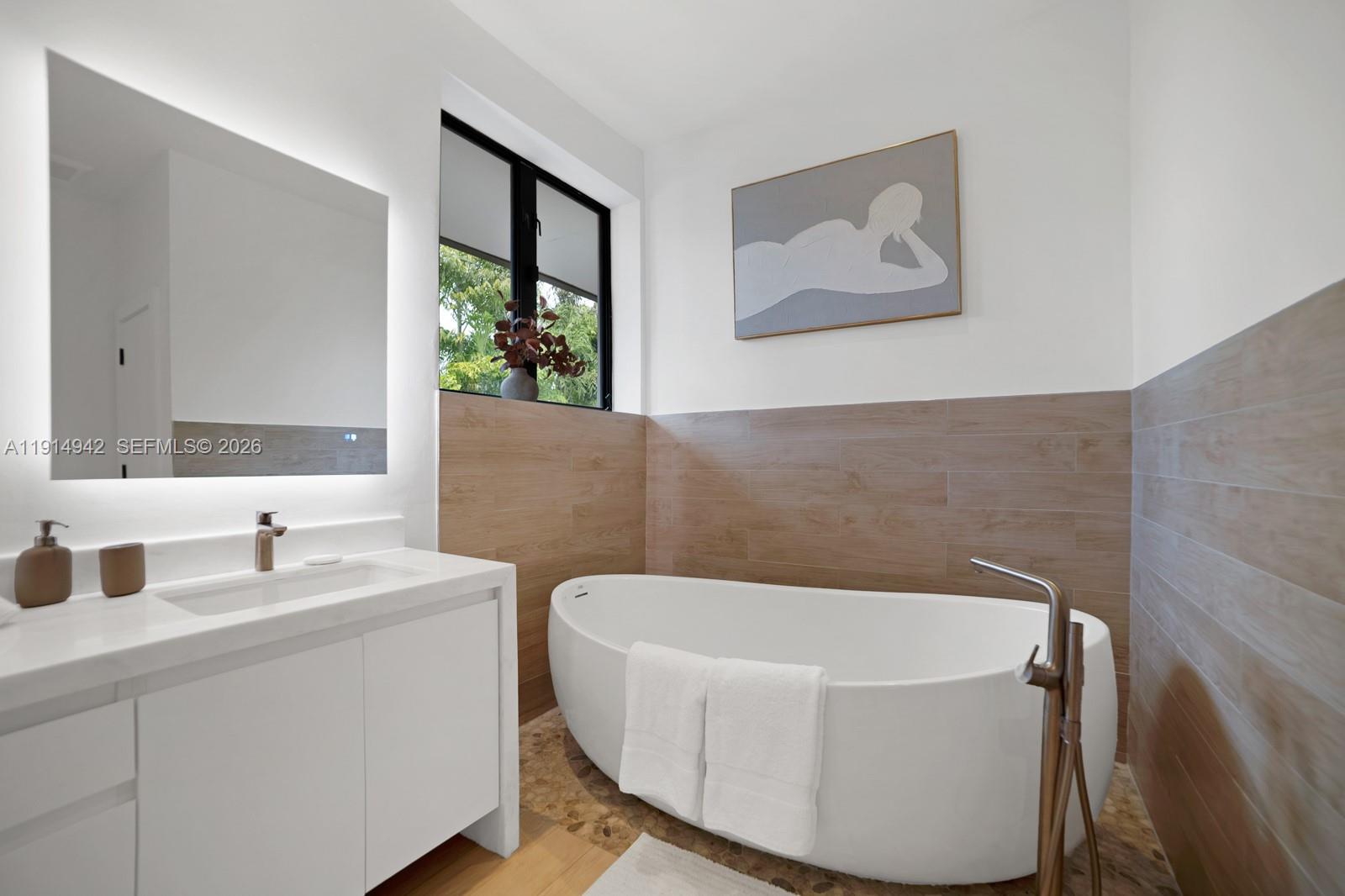 5735 North Bay Road Miami Beach, FL 33140 - Photo 34 of 59 a bathroom with a tub and sink