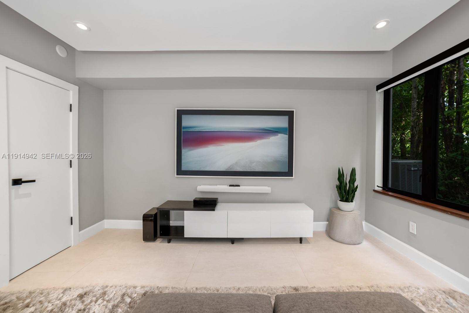 5735 North Bay Road Miami Beach, FL 33140 - Photo 38 of 59 a living room with furniture and a flat screen tv