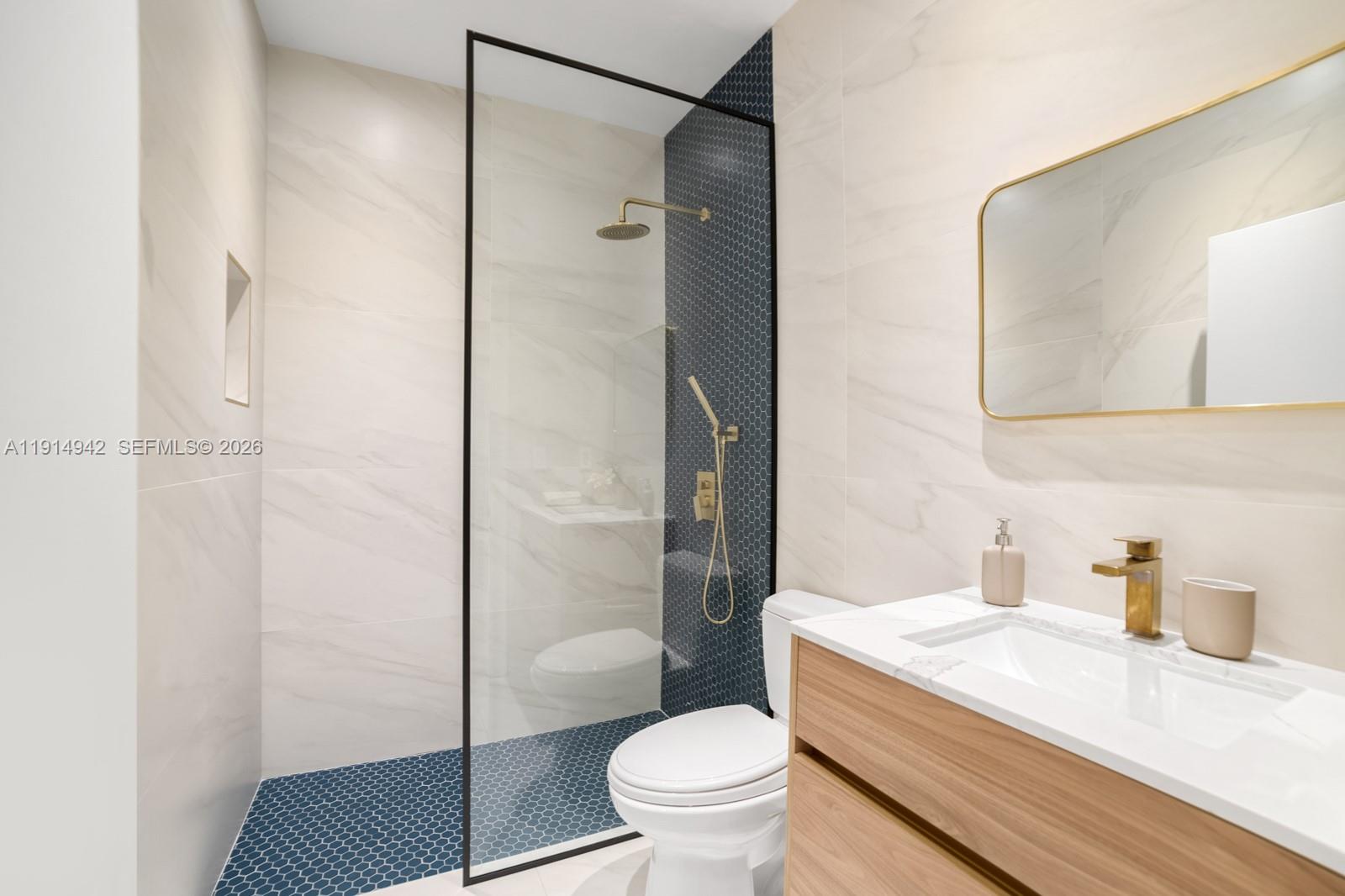5735 North Bay Road Miami Beach, FL 33140 - Photo 39 of 59 a bathroom with a sink a toilet and shower