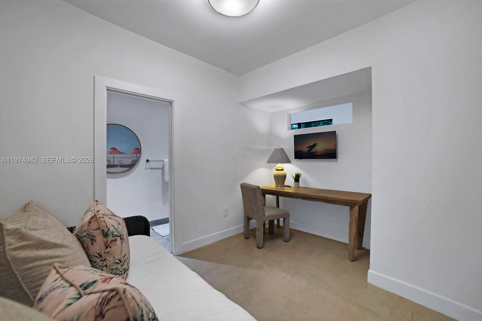 5735 North Bay Road Miami Beach, FL 33140 - Photo 44 of 59 a bedroom with a bed and a a flat screen tv