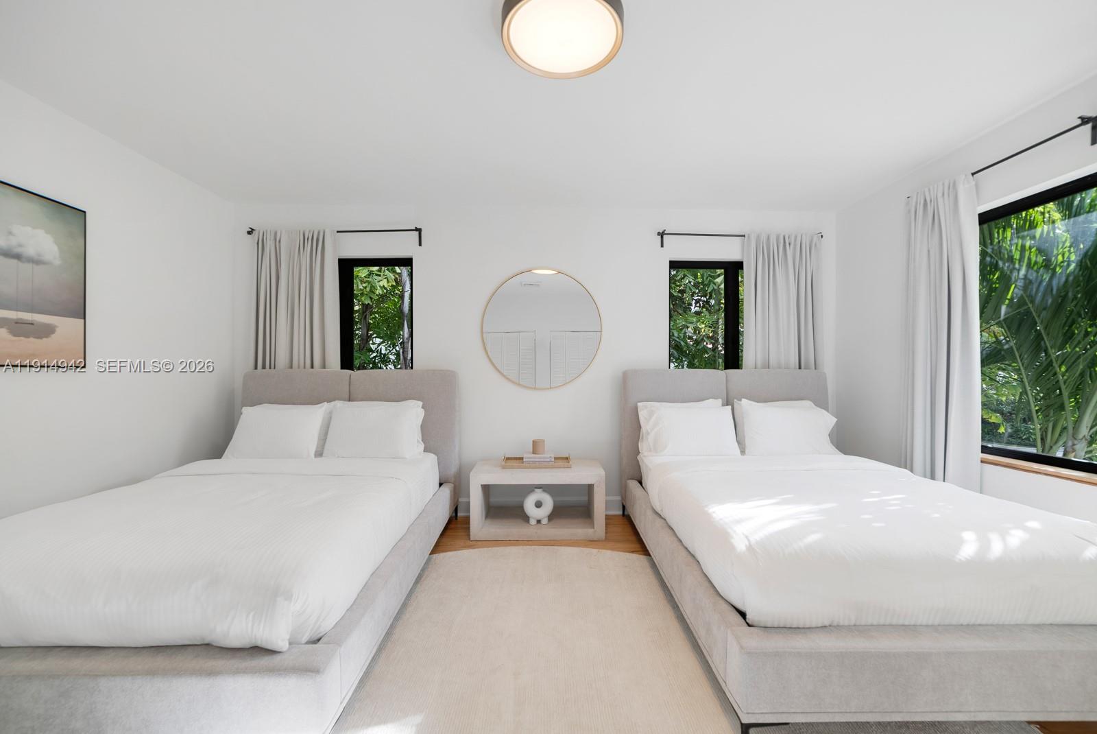 5735 North Bay Road Miami Beach, FL 33140 - Photo 46 of 59 a large white bed in a white room