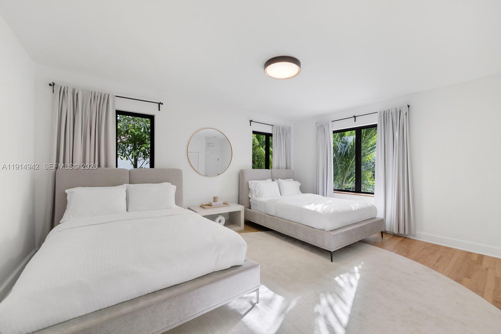 5735 North Bay Road Miami Beach, FL 33140 - Photo 47 of 59 a bedroom with a large bed and windows