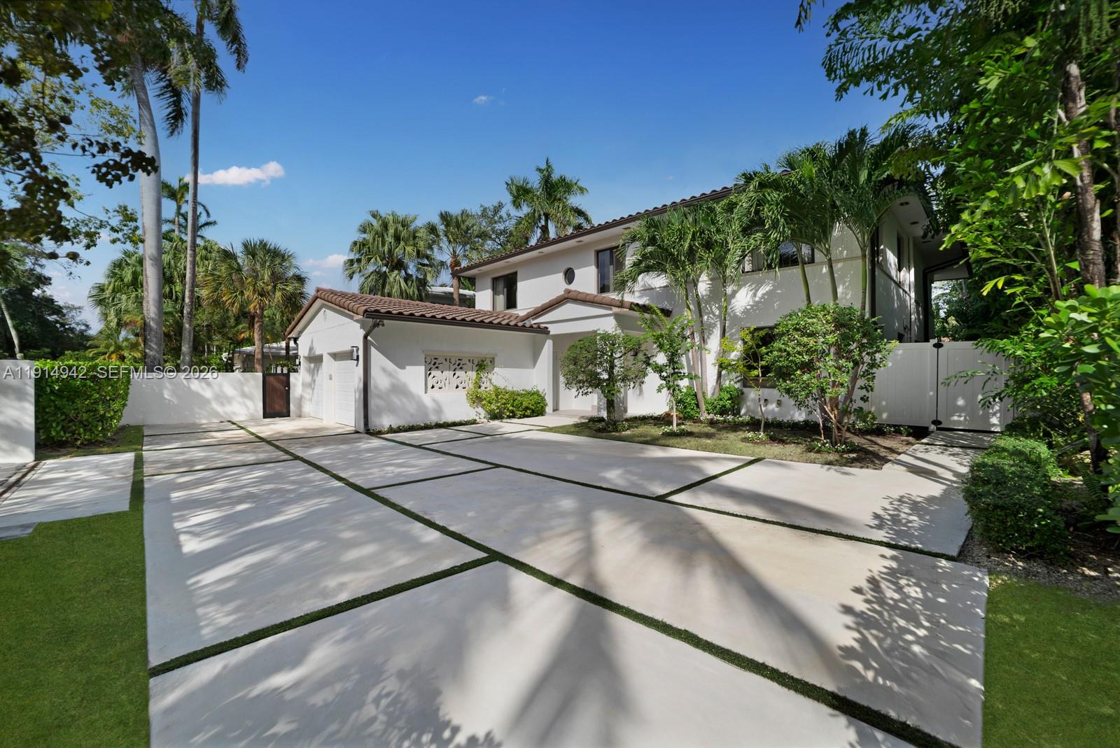5735 North Bay Road Miami Beach, FL 33140 - Photo 5 of 59 a view of a house with street next to a yard
