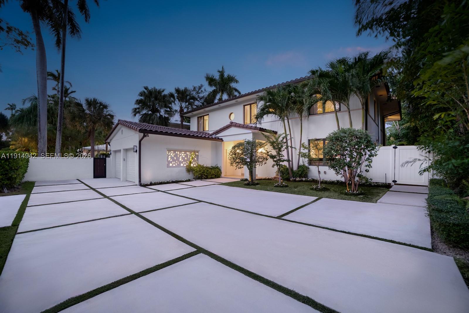 5735 North Bay Road Miami Beach, FL 33140 - Photo 54 of 59 a front view of a house with a yard and a garage