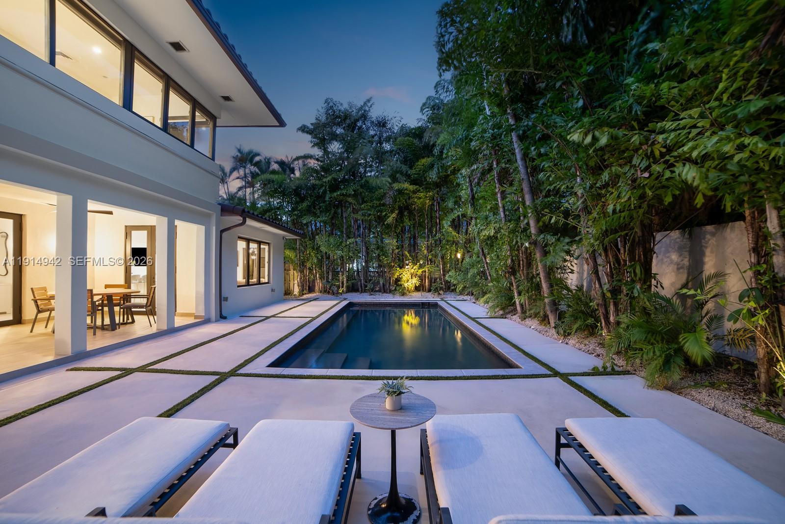 5735 North Bay Road Miami Beach, FL 33140 - Photo 55 of 59 a aerial view of a house with swimming pool and porch with furniture