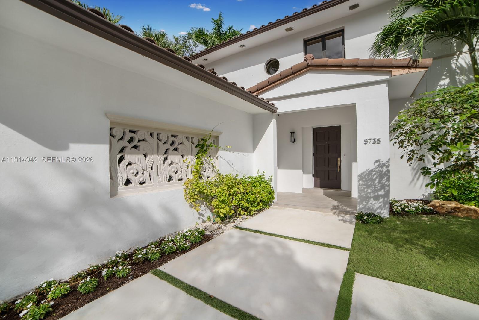 5735 North Bay Road Miami Beach, FL 33140 - Photo 6 of 59 a front view of a house with garden