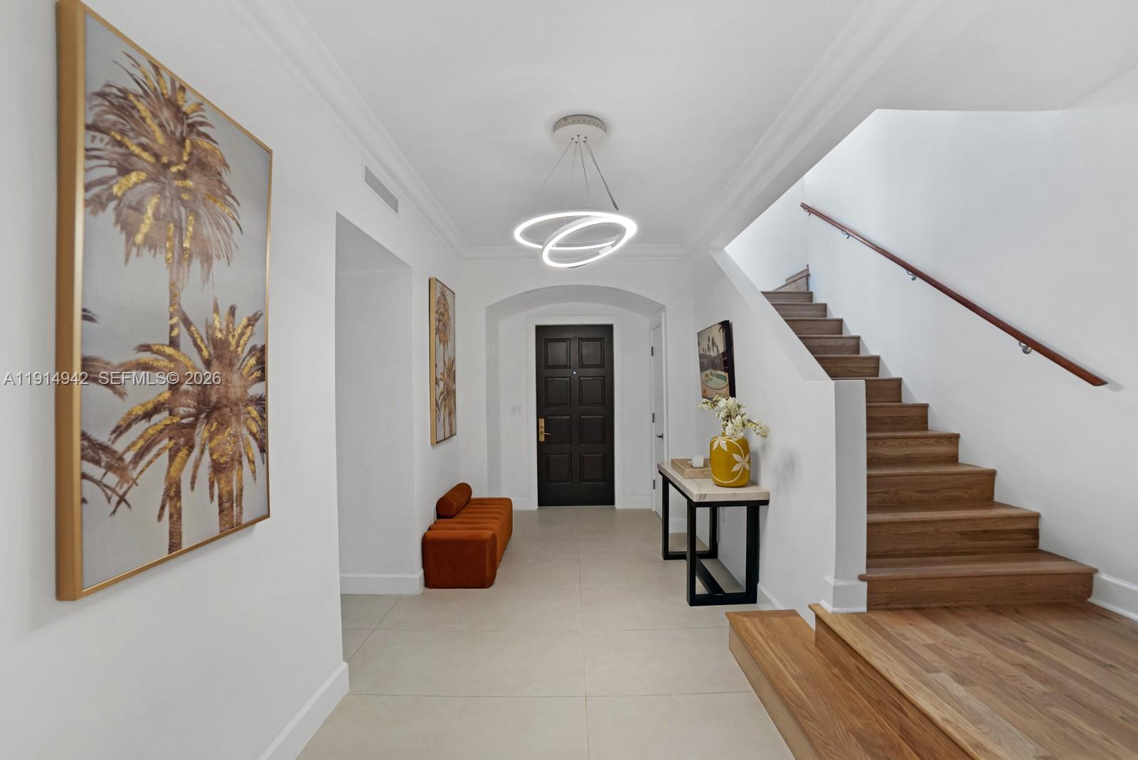 5735 North Bay Road Miami Beach, FL 33140 - Photo 7 of 59 a view of a hallway with entryway wooden floor and front door
