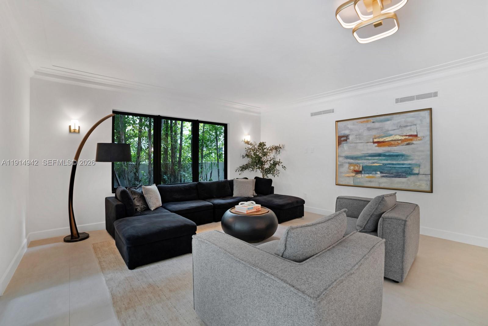5735 North Bay Road Miami Beach, FL 33140 - Photo 9 of 59 a living room with furniture and a large window