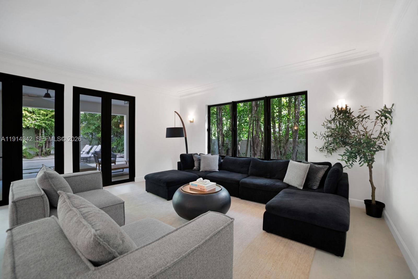 5735 North Bay Road Miami Beach, FL 33140 - Photo 10 of 59 a living room with furniture and a large window