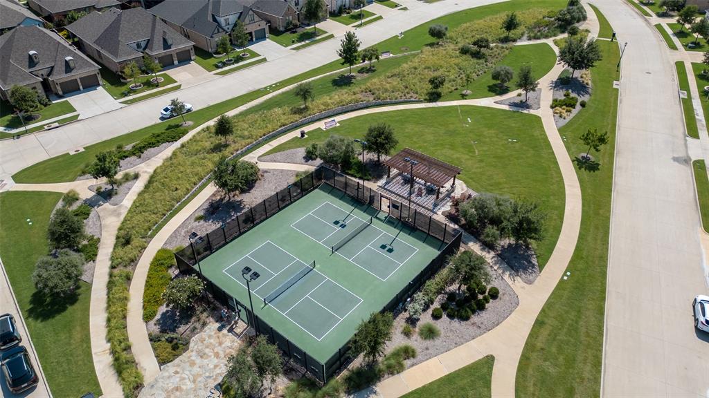 8440 Colburn The Colony, TX 75056 - Photo 28 of 34 Stay active and connected with The Tribute's dedicated pickleball courts, a popular community amenity perfect for players of all skill levels. Surrounded by scenic green space, walking trails, and gathering areas, these courts provide a fun and social environment to enjoy one of the nation's fastest-growing sports right in your neighborhood.