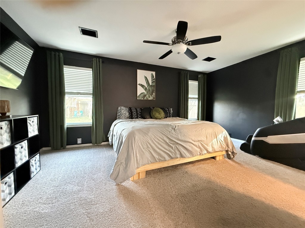 11903 Ezekiel Road Tomball, TX 77375 - Photo 19 of 39 a bedroom with a bed and a ceiling fan