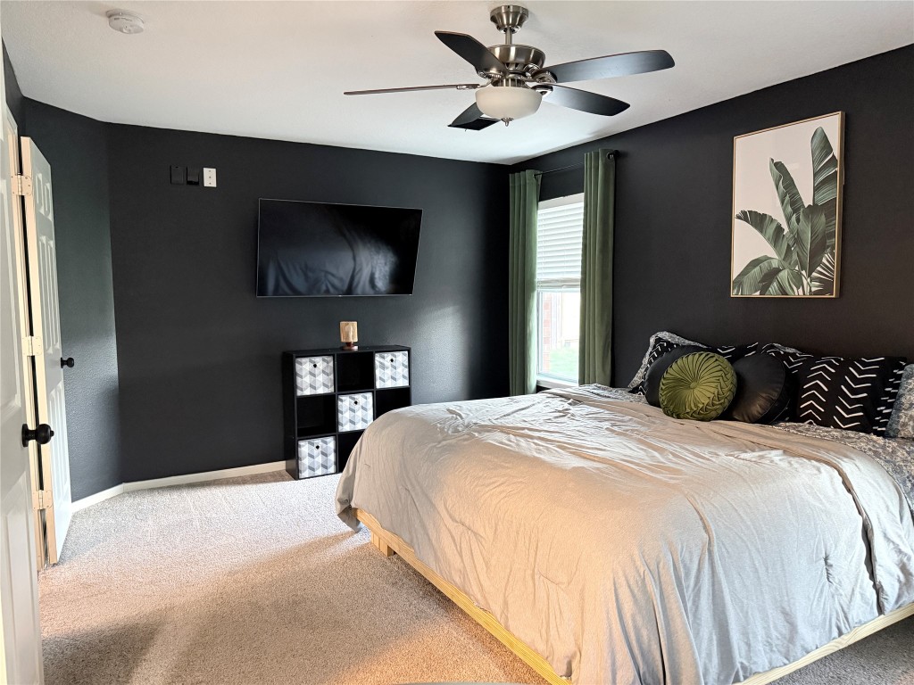 11903 Ezekiel Road Tomball, TX 77375 - Photo 20 of 39 a bedroom with a bed and a chandelier