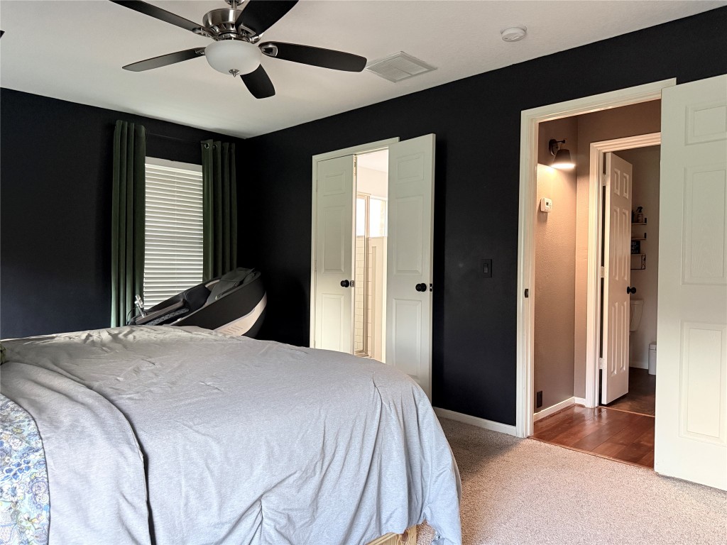 11903 Ezekiel Road Tomball, TX 77375 - Photo 21 of 39 a bedroom with a large bed and a chandelier