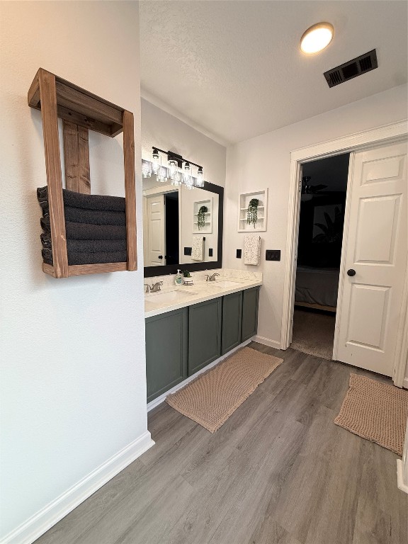 11903 Ezekiel Road Tomball, TX 77375 - Photo 23 of 39 a kitchen with stainless steel appliances a sink cabinets and wooden floor