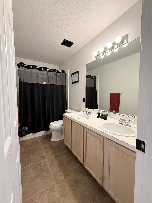 11903 Ezekiel Road Tomball, TX 77375 - Photo 32 of 39 a bathroom with a double vanity sink and a mirror