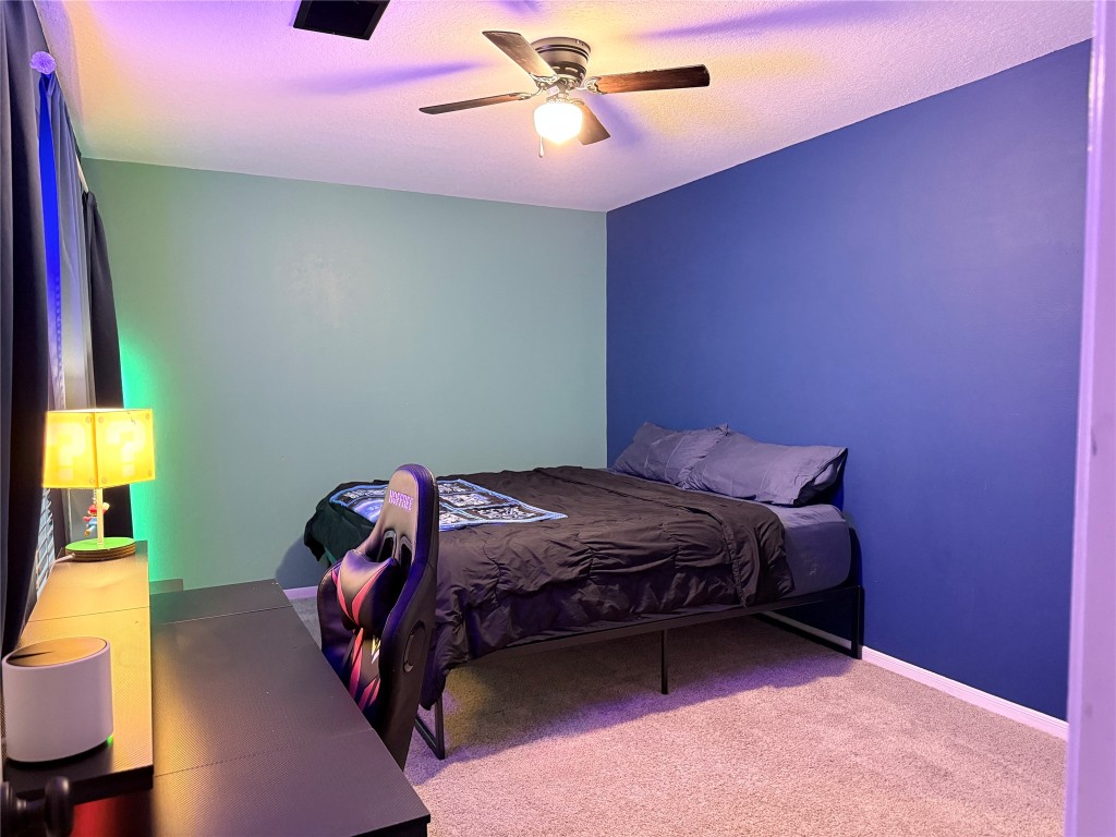 11903 Ezekiel Road Tomball, TX 77375 - Photo 36 of 39 a bedroom with a bed and a chandelier