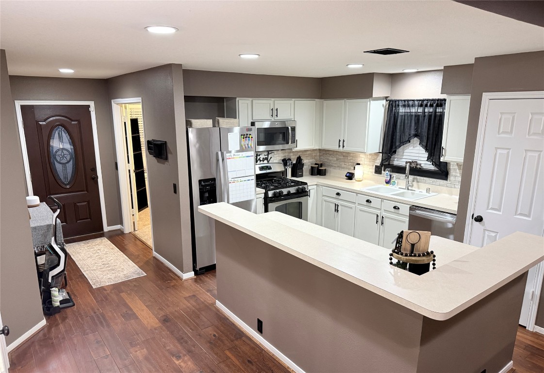 11903 Ezekiel Road Tomball, TX 77375 - Photo 4 of 39 a kitchen with a sink appliances and cabinets