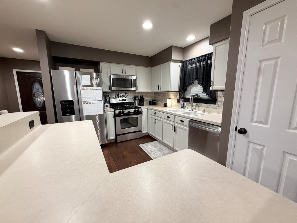 11903 Ezekiel Road Tomball, TX 77375 - Photo 7 of 39 a kitchen with stainless steel appliances granite countertop a refrigerator stove microwave and sink