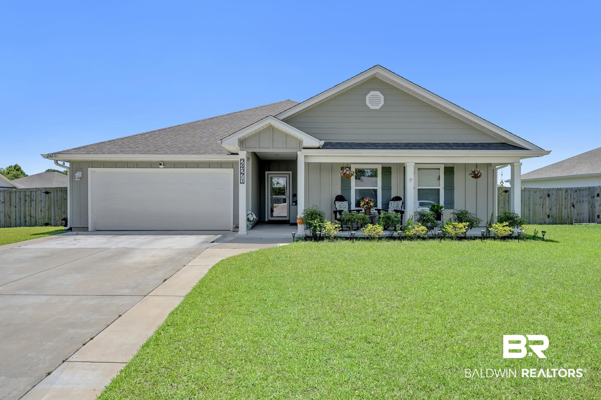 24271 Ringneck Loop Elberta, AL 36530 - Photo 34 of 44 Single-story home featuring light gray siding, a covered front porch, a gabled roofline, a two-car garage, and a concrete driveway