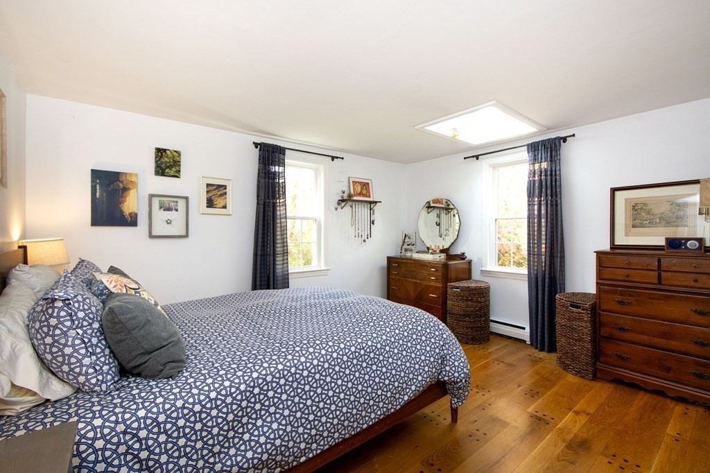 32 Shadwell Road Scituate, MA 02066 - Photo 18 of 32 a bedroom with a bed and dresser with mirror