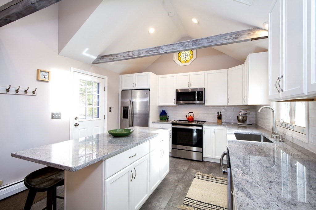 32 Shadwell Road Scituate, MA 02066 - Photo 7 of 32 a kitchen with stainless steel appliances granite countertop a sink dishwasher a stove a refrigerator a microwave oven with white cabinets and wooden floor