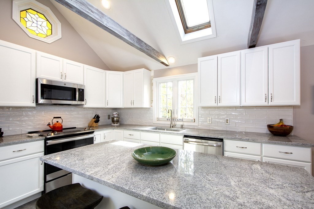 32 Shadwell Road Scituate, MA 02066 - Photo 8 of 32 a kitchen with stainless steel appliances granite countertop a sink a stove and a microwave