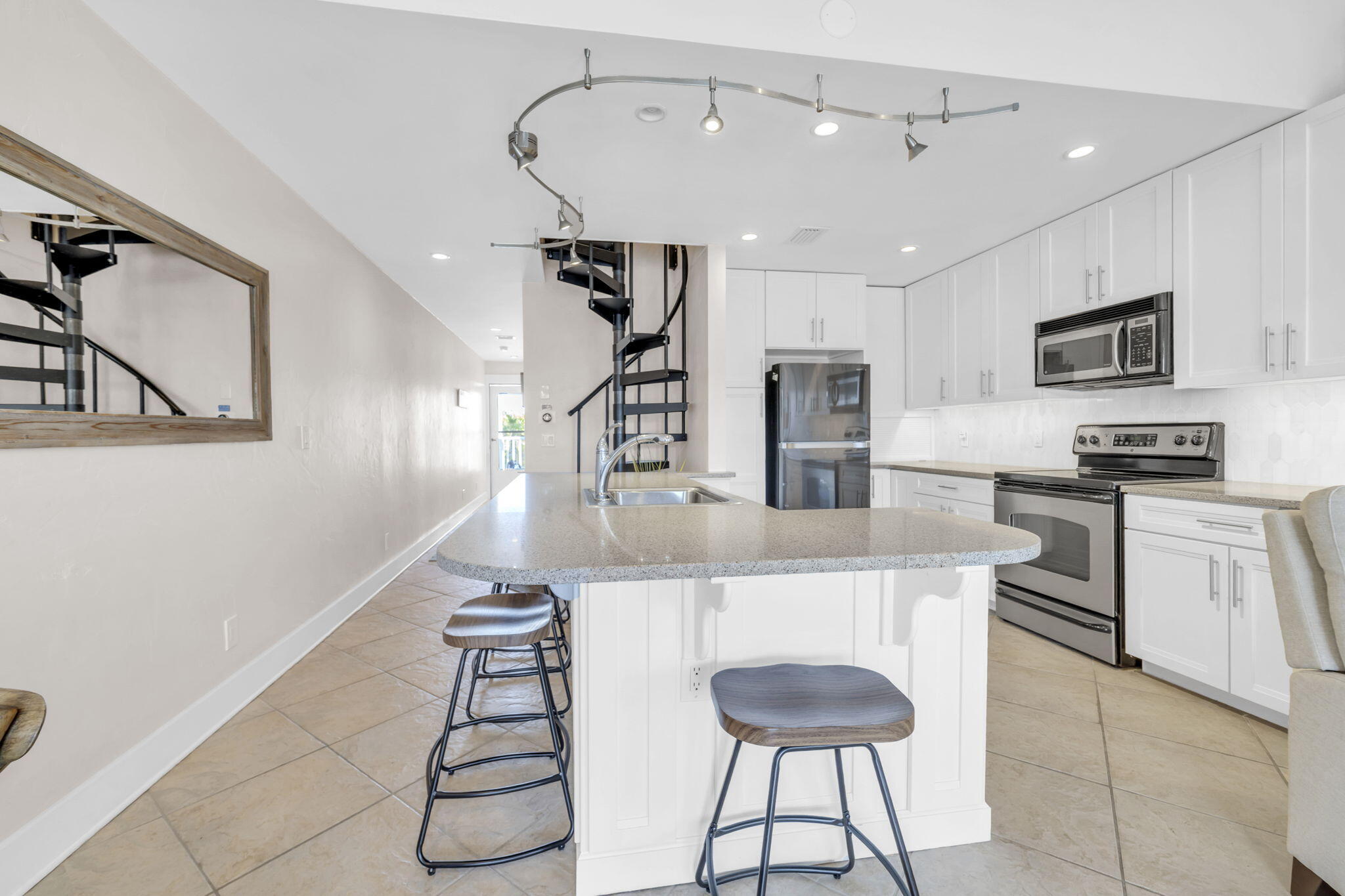 4984 West County Highway 30A, Unit 4B Santa Rosa Beach, FL 32459 - Photo 13 of 37 a kitchen with kitchen island a counter top space appliances and cabinets