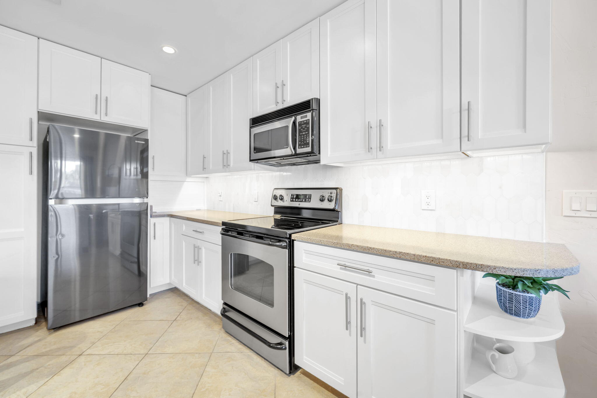4984 West County Highway 30A, Unit 4B Santa Rosa Beach, FL 32459 - Photo 14 of 37 a kitchen with stainless steel appliances granite countertop a refrigerator sink and white cabinets