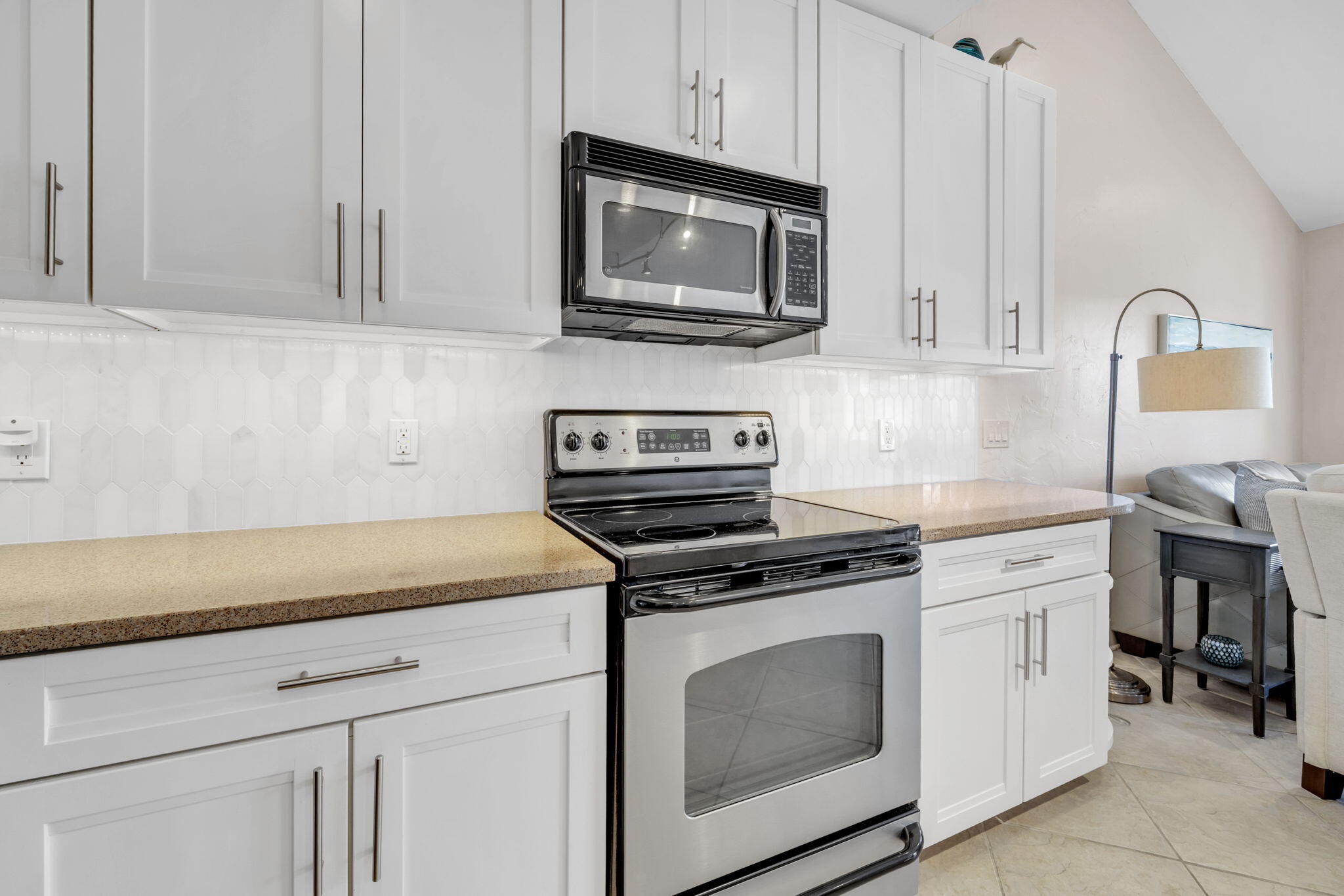 4984 West County Highway 30A, Unit 4B Santa Rosa Beach, FL 32459 - Photo 16 of 37 a kitchen with white cabinets and stainless steel appliances