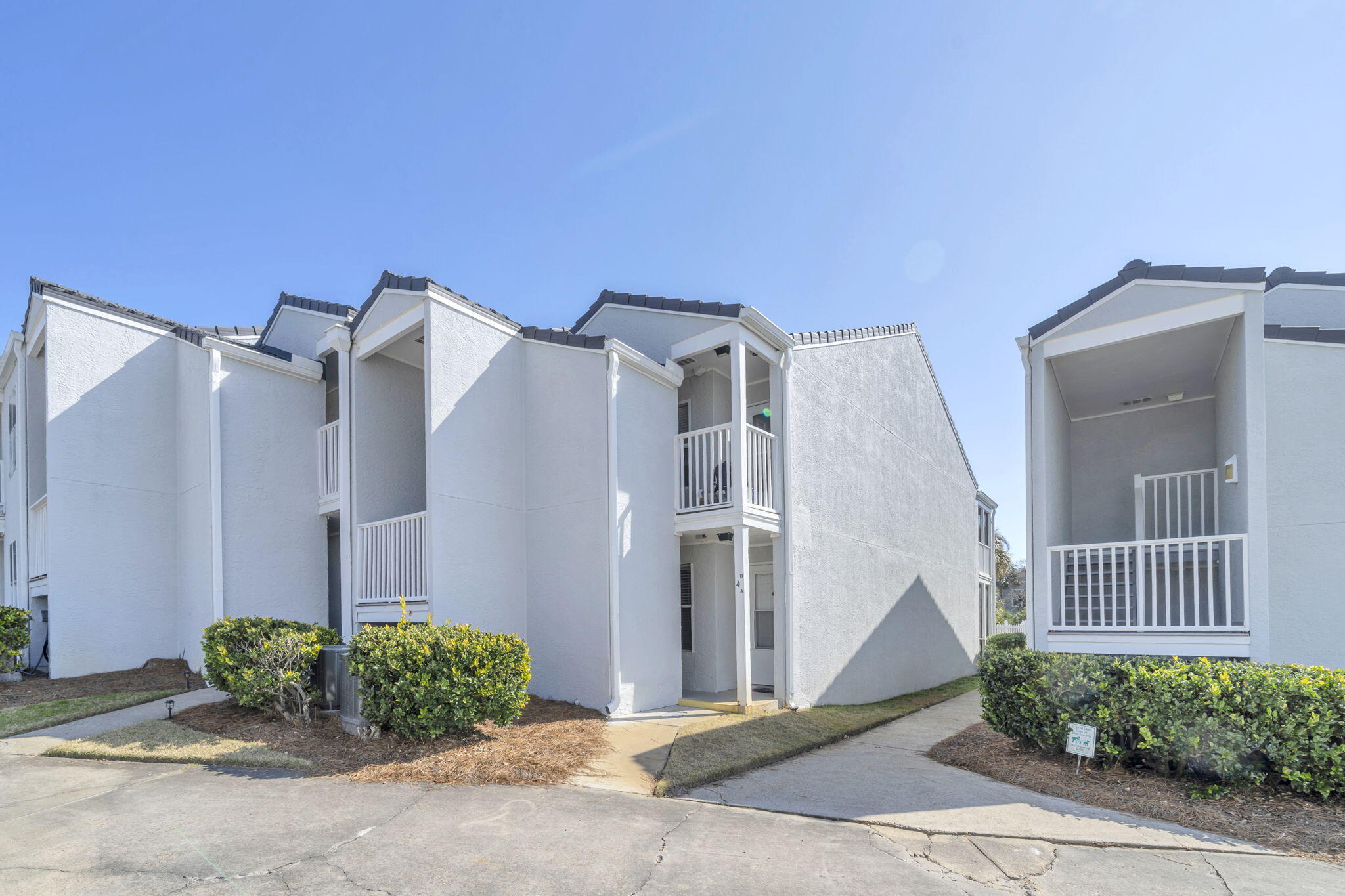 4984 West County Highway 30A, Unit 4B Santa Rosa Beach, FL 32459 - Photo 3 of 37 a front view of a house with garden