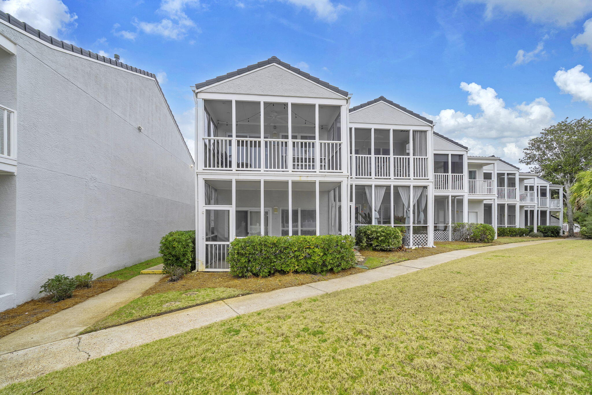 4984 West County Highway 30A, Unit 4B Santa Rosa Beach, FL 32459 - Photo 31 of 37 a view of a building with a yard
