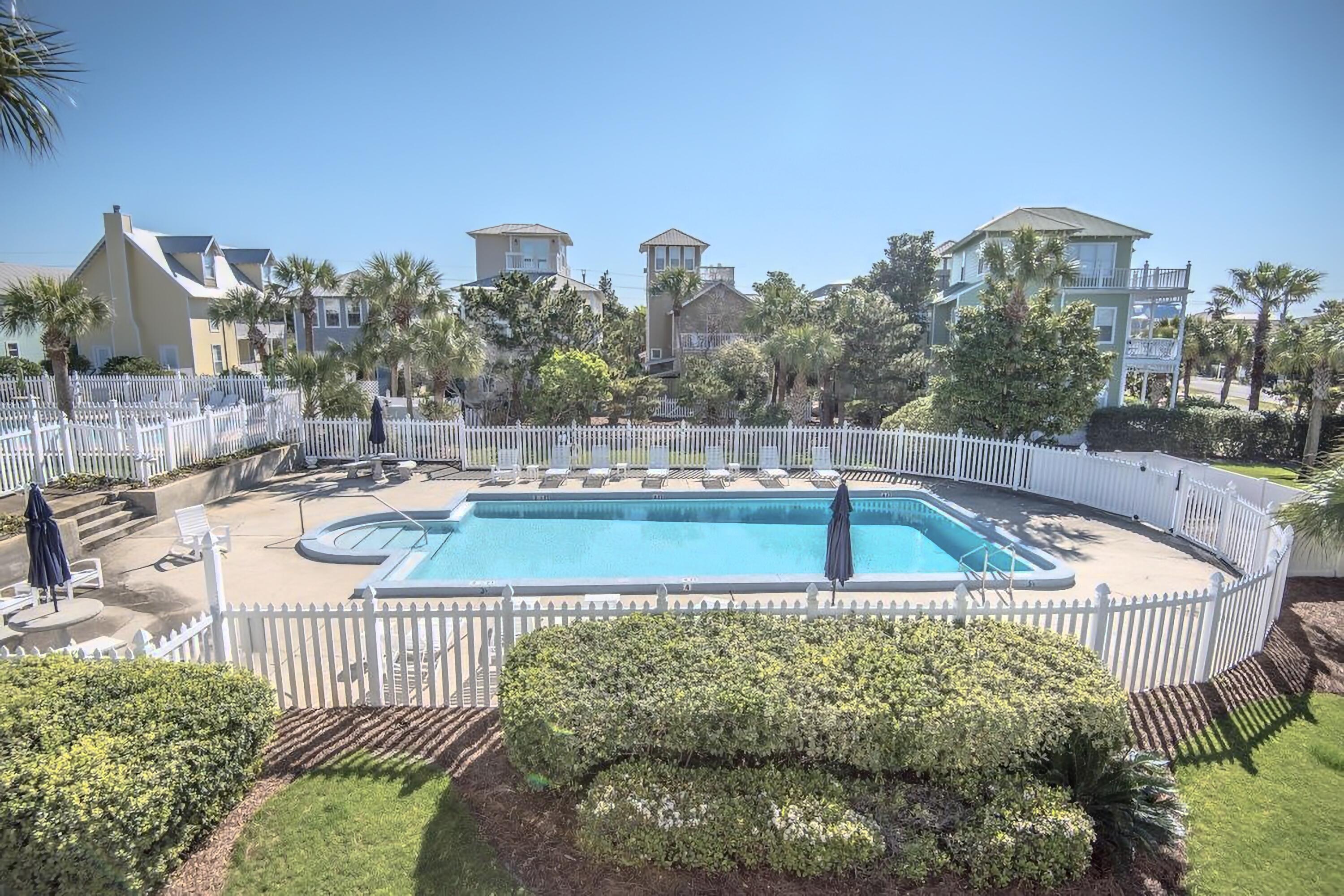 4984 West County Highway 30A, Unit 4B Santa Rosa Beach, FL 32459 - Photo 33 of 37 a view of a swimming pool with a patio and couches chairs