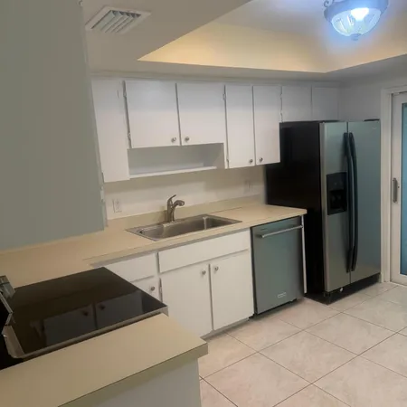 a kitchen with cabinets and appliances