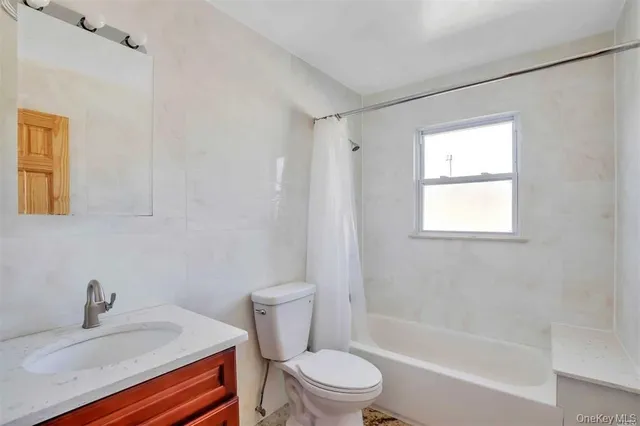 a bathroom with a sink toilet a mirror and shower