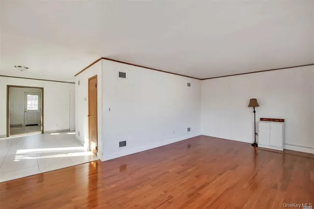 a view of a room with wooden floor